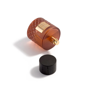Brown textured perfume bottle with gold cap on a white background